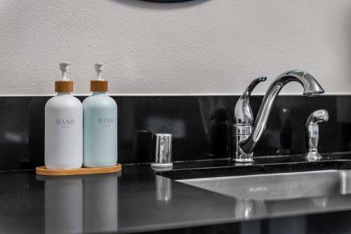 zwei Flaschen mit Duftstoffen auf einer Theke neben einem Waschbecken in der Unterkunft Stylish in Sunny Santa Monica walk to Beach & Pier in Los Angeles