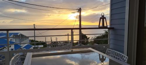 a view of the ocean from the balcony of a house at Les Gîtes Kajou in Bouillante