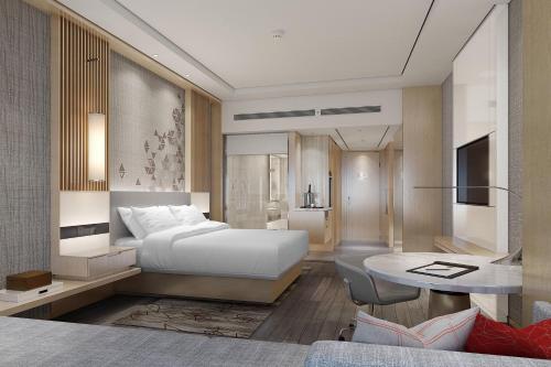a bedroom with a white bed and a desk at Courtyard by Marriott Shanghai Songjiang in Songjiang