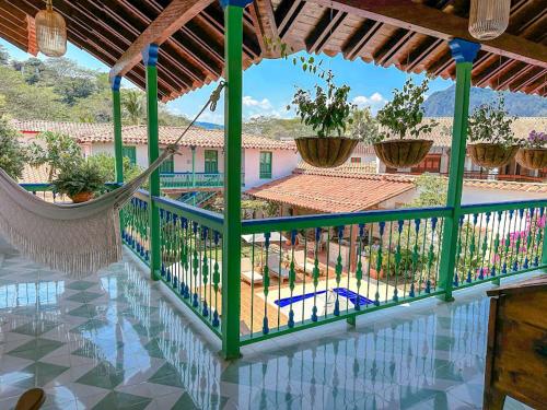 a porch with a hammock and a pool at Casa Cedrela Hotel Boutique by HMC -Cauca Viejo- Mayores de 14 años in Jericó