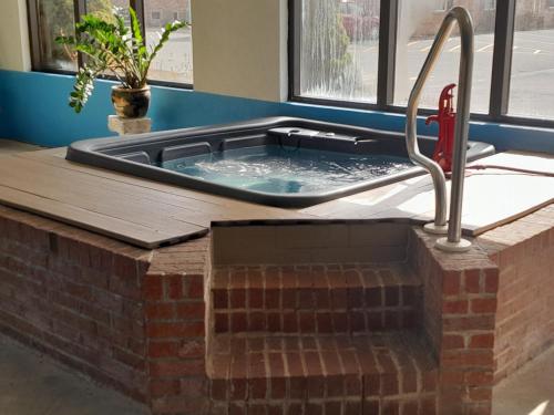 a hot tub in a room with a sink at Comfort Inn Duncansville - Altoona in Duncansville