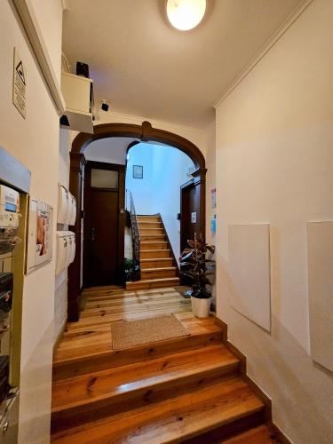a hallway with wooden floors and an archway at Vila Queirós, 6 in Lisbon