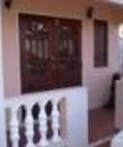 a front door of a house with a porch at LeMarida Suites in Saint Peter