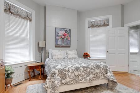a bedroom with a bed and two windows at City Nest in FAN Museums Free Parking in Richmond