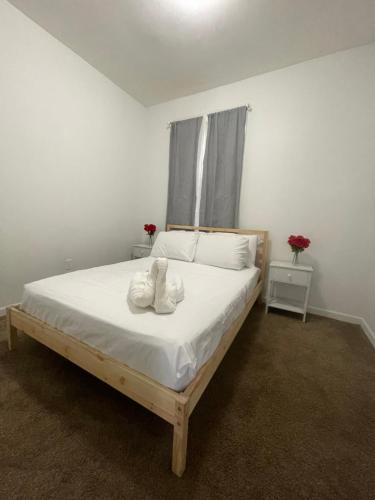 a bedroom with a bed with two white towels on it at SUITE JESUS ROOM 3 in Paterson