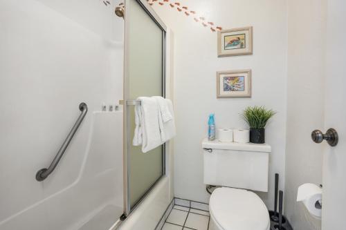 a white bathroom with a shower and a toilet at Plantation Hale G14 in Kapaa