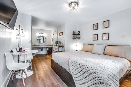 a bedroom with a bed and a desk and a table at Mount Worthington Room 6 at Mount Walker Inn in Quilcene