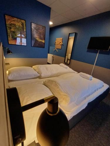 a hotel room with two beds and a tv at Double Room 9 In Saeby in Sæby
