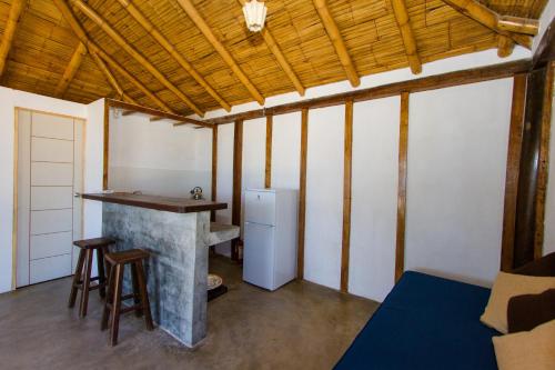 a kitchen with a counter and a stove in a room at Hoja de Palma Bungalows in Canoas De Punta Sal