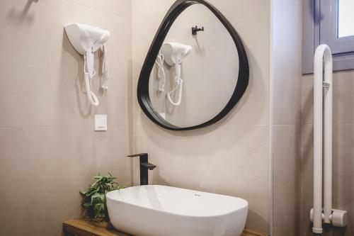 a bathroom with a white sink and a mirror at Votsalo Tolo in Tolo