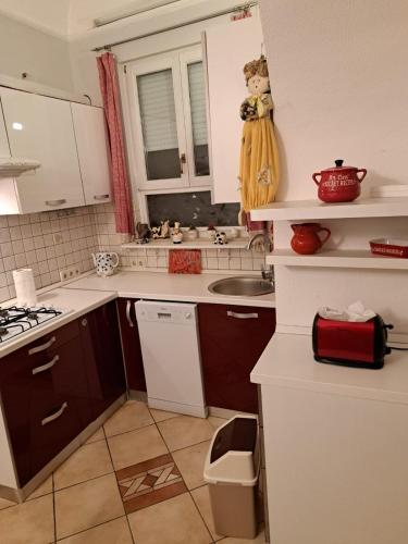 a small kitchen with a sink and a counter at LuMiDo in Osijek