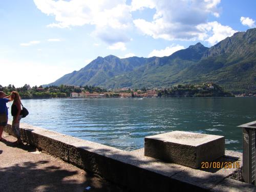 two people standing on a bridge over a body of water at Casa Amata in Lecco