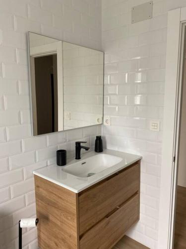 a bathroom with a sink and a mirror at La Casina de Rodiles in Liñero