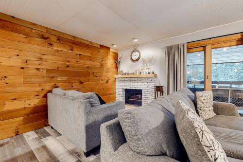 a living room with a couch and a fireplace at Pico Mountain Perch, Unit B22 in Mendon
