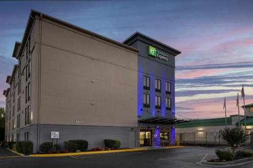a hotel building with a green sign on it at Holiday Inn Express Washington DC-BW Parkway by IHG in Hyattsville