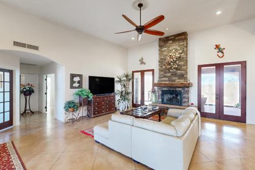 a living room with a couch and a fireplace at Saguaro Sunrise in Tucson
