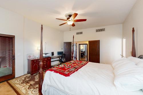 a bedroom with a bed and a ceiling fan at Saguaro Sunrise in Tucson
