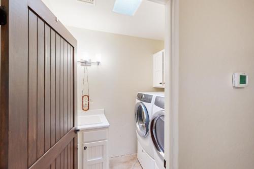 a laundry room with a washer and dryer at Saguaro Sunrise in Tucson