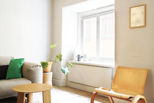 a living room with a couch and a window at The architects' house in Stockholm