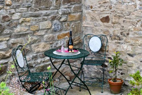 a table and two chairs with a bottle of wine at Ellerton Lodge Bed and Breakfast Swaledale in Richmond