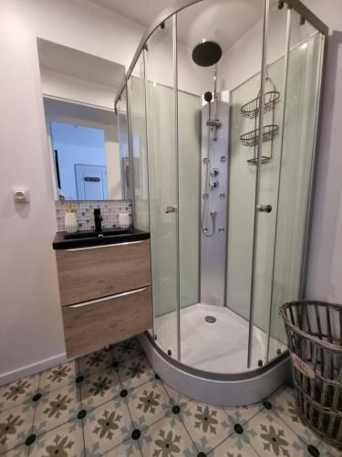 une salle de bain avec douche et lavabo dans l'établissement Les flocons enchantés t2 rdc neuf, à La Bourboule
