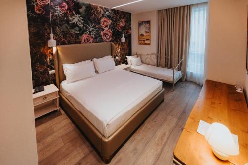 a hotel room with a bed and a couch at Tirana Resort Radhime in Radhimë