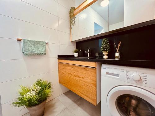 a laundry room with a washing machine and plants at Residence Kyrenia in Kyrenia