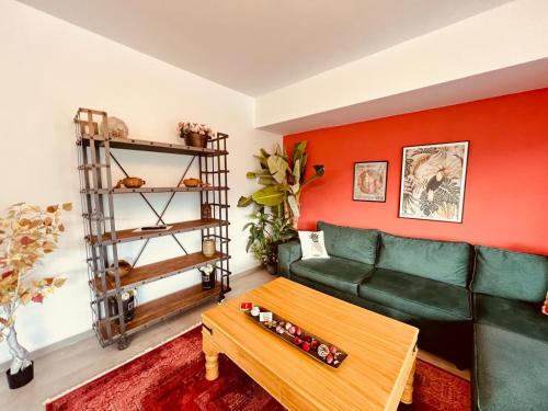 a living room with a green couch and a table at Residence Kyrenia in Kérynia