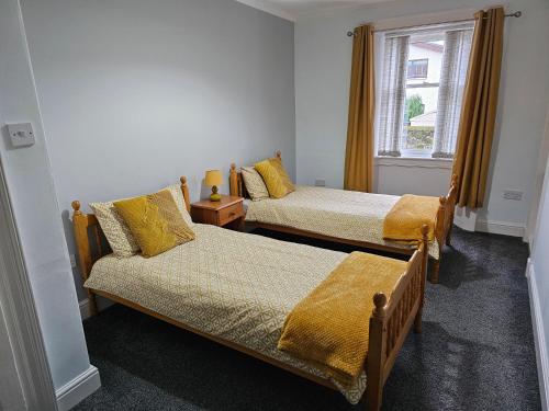 a bedroom with two beds and a window at ALLARDYCE in Kincardine