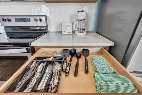 a drawer in a kitchen with knives and utensils at Beach Views on Cape Fear in Carolina Beach