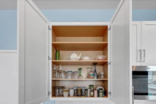 a kitchen pantry with white cabinets at Beach Views on Cape Fear in Carolina Beach