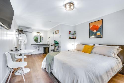 a white bedroom with a bed and a desk at Mount Bretherton Room 8 at Mount Walker Inn in Quilcene