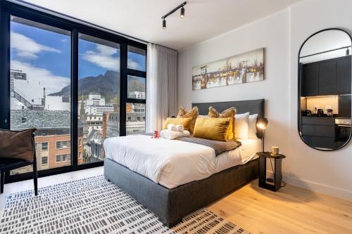 a bedroom with a large bed and a large window at The Tokyo 710 in Cape Town
