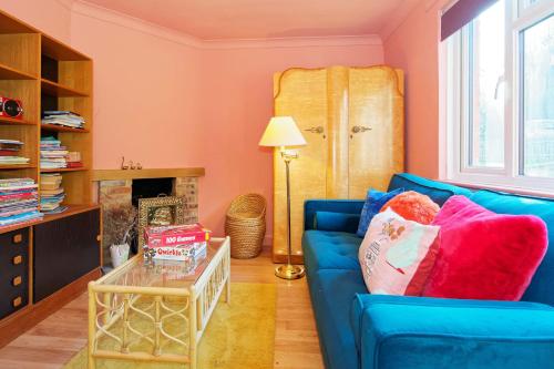a living room with a blue couch and a table at Kent Downs Cottage Modern Family Retreat near Canterbury in Canterbury