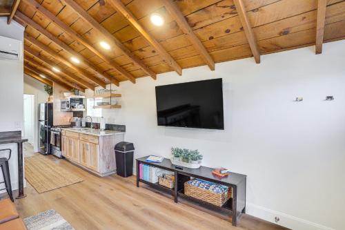 a living room with a flat screen tv on a wall at Cedar City Studio Retreat Patio, Fire Pit and Grill in Cedar City