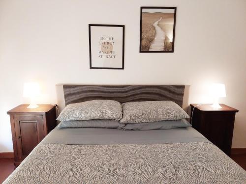 a bedroom with a bed and two pictures on the wall at The Smart Choice Apartments in Florence