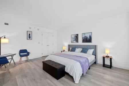 a bedroom with a large bed and a table and chairs at CozySuites at Showboat Bold 2BR 3BA Beachfront in Atlantic City
