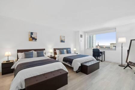 a hotel room with two beds and a window at CozySuites at Showboat Bold 2BR 3BA Beachfront in Atlantic City