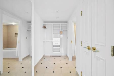 two views of a bathroom with a shower and a door at CozySuites at Showboat Bold 2BR 3BA Beachfront in Atlantic City
