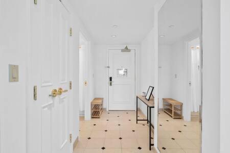 a hallway with white walls and a tiled floor at CozySuites at Showboat Bold 2BR 3BA Beachfront in Atlantic City