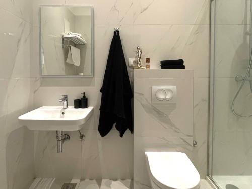 a bathroom with a toilet and a sink and a shower at Premium Class Apartments III in Zagreb