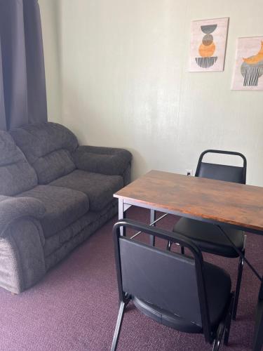 a living room with a couch and a table at Midtown Inn & Suites in La Junta