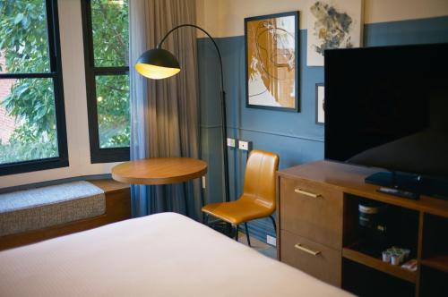 a hotel room with a bed and a table and a tv at Hotel Julian in San Francisco