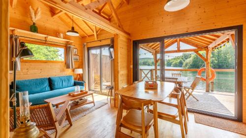 a living room with a blue couch and a table at Lieu Dieu, Domaine de Campagne in Beauchamps