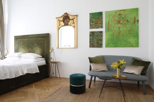 a bedroom with a bed and a chair and a mirror at Premium Class Apartments III in Zagreb