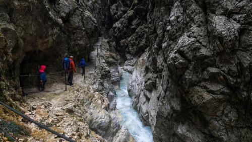 a group of people walking through a mountain canyon at Ferienwohnung Bergspitz in Grainau