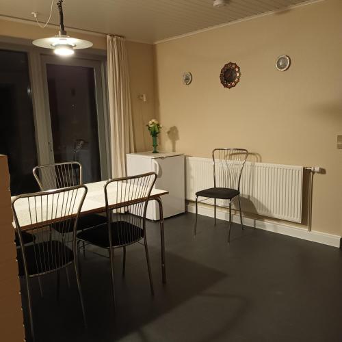 a dining room with chairs and a table and a refrigerator at Villa in Brande in Gammel Blåhøj