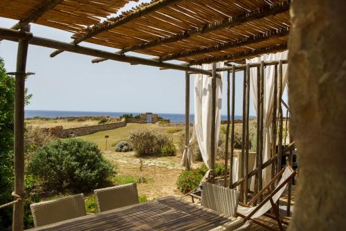 a porch with chairs and a view of the ocean at Residenza A Cova in Carloforte