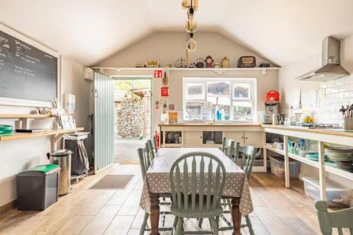 a dining room with a table and chairs in a kitchen at Mayo Glamping in Castlebar