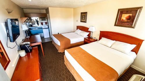 a hotel room with two beds and a kitchen at Travelodge by Wyndham Valleyview AB in Valleyview
